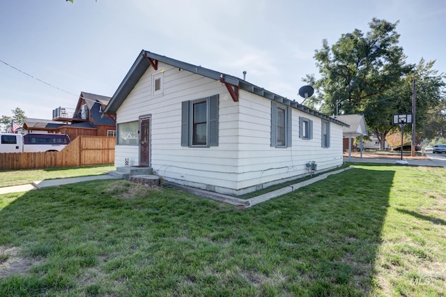 view of side of property featuring a yard