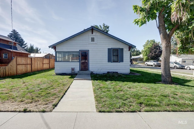 bungalow-style house featuring a front lawn