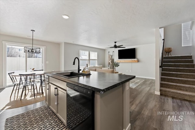 kitchen featuring a sink, dark countertops, dark wood finished floors, and dishwasher