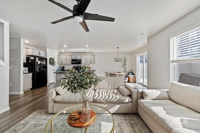 living room with ceiling fan, recessed lighting, wood finished floors, visible vents, and baseboards