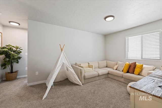 living room featuring baseboards and light colored carpet