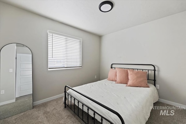 carpeted bedroom with baseboards