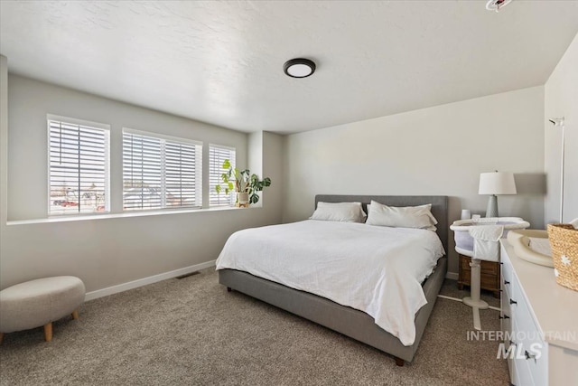 carpeted bedroom with visible vents and baseboards