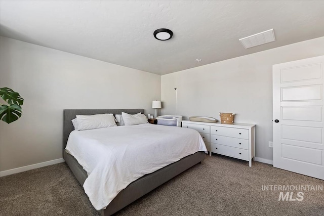 carpeted bedroom featuring visible vents and baseboards