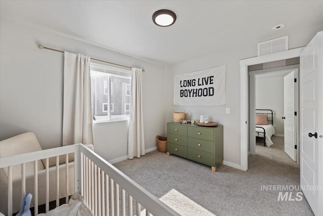 carpeted bedroom with a nursery area, baseboards, and visible vents