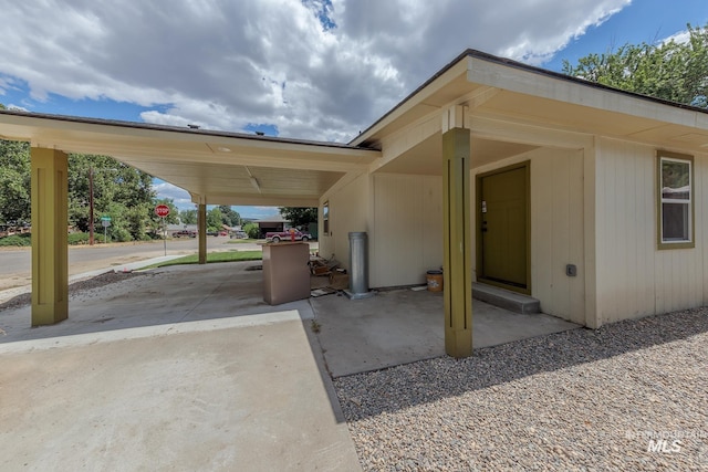 view of vehicle parking featuring a carport