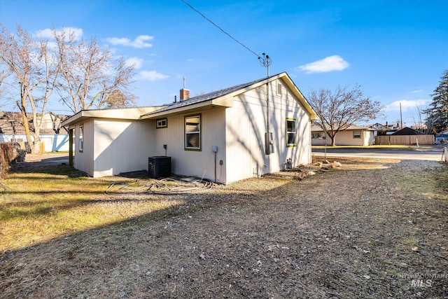 rear view of house with central AC unit