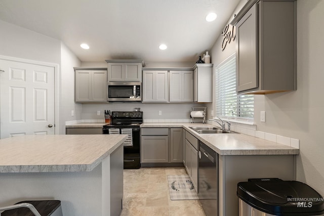 13221 S Clarion River Ave, Nampa, ID 83686 - kitchen with black / electric stove, stainless steel microwave, gray cabinetry, dishwashing machine, and a sink