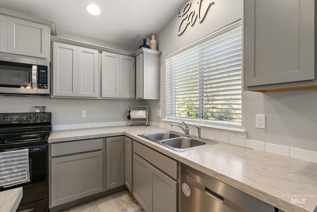 13221 S Clarion River Ave, Nampa, ID 83686 - kitchen featuring stainless steel appliances, a sink, gray cabinetry, and light countertops