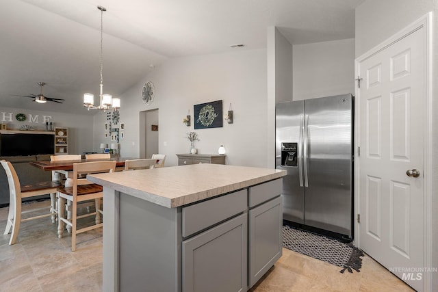 13221 S Clarion River Ave, Nampa, ID 83686 - kitchen with stainless steel fridge, gray cabinets, a center island, light countertops, and ceiling fan