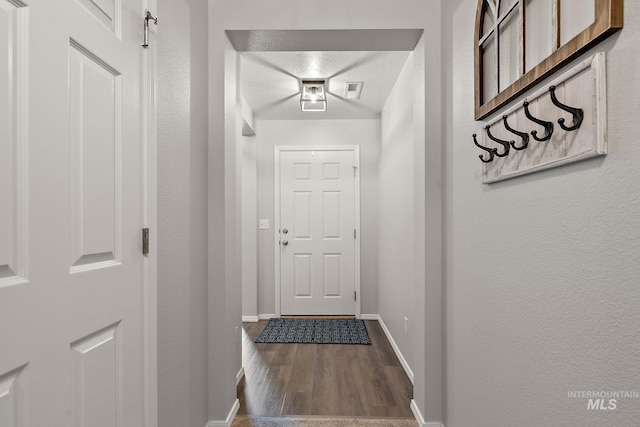 13221 S Clarion River Ave, Nampa, ID 83686 - doorway to outside with baseboards and dark wood-style floors
