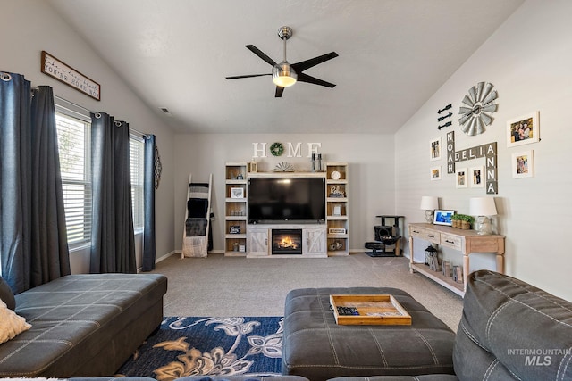 13221 S Clarion River Ave, Nampa, ID 83686 - carpeted living area with ceiling fan, baseboards, a glass covered fireplace, and vaulted ceiling