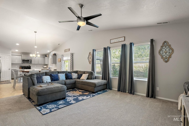 13221 S Clarion River Ave, Nampa, ID 83686 - living room with plenty of natural light, vaulted ceiling, ceiling fan, light carpet, and baseboards