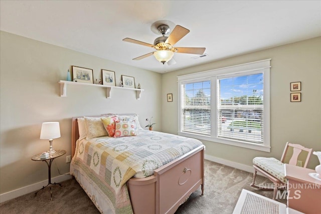 bedroom with baseboards, visible vents, ceiling fan, and light colored carpet