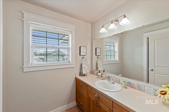 bathroom with vanity and baseboards