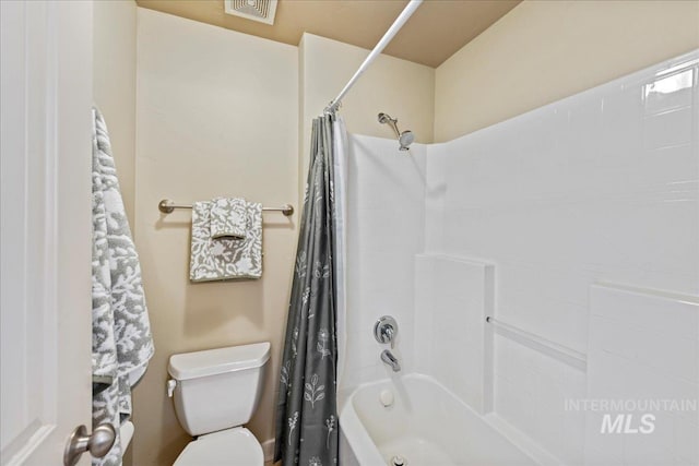 bathroom featuring visible vents, shower / tub combo, and toilet
