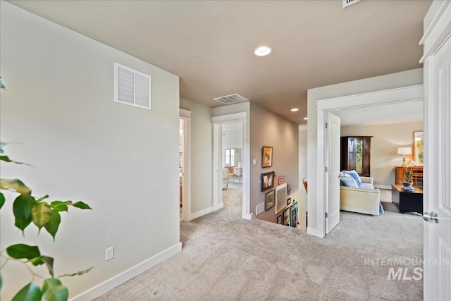 corridor with visible vents, carpet flooring, baseboards, and recessed lighting