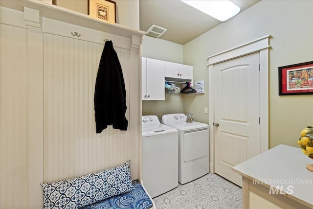 laundry room with cabinet space, visible vents, and washer and dryer