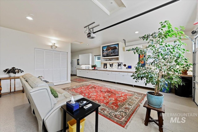 living area featuring recessed lighting and light speckled floor