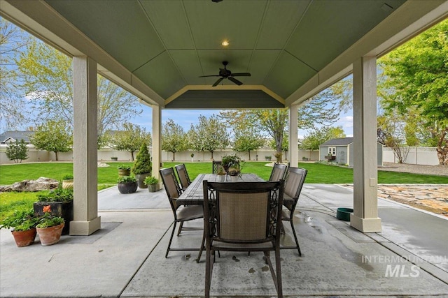 view of patio / terrace with outdoor dining area, a fenced backyard, and ceiling fan