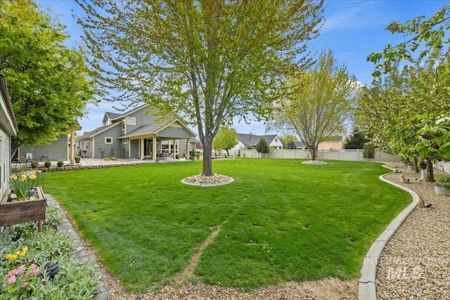view of yard with a fenced backyard and a patio