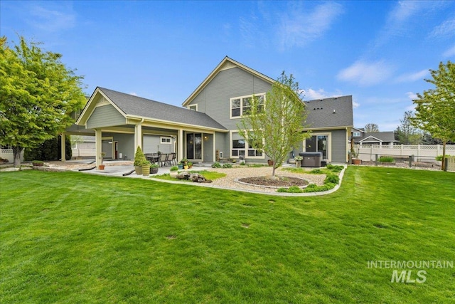 back of property featuring fence, a patio, a yard, and roof with shingles