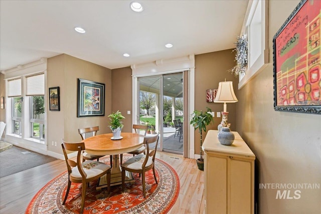 dining space featuring light wood-type flooring, recessed lighting, and plenty of natural light