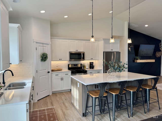 815 Emerald Dr N, Kimberly, ID 83341 - kitchen with light countertops, white cabinetry, a sink, light wood finished floors, and appliances with stainless steel finishes
