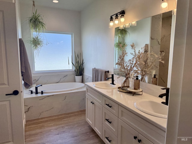 815 Emerald Dr N, Kimberly, ID 83341 - full bath with double vanity, a sink, a bath, and wood finished floors