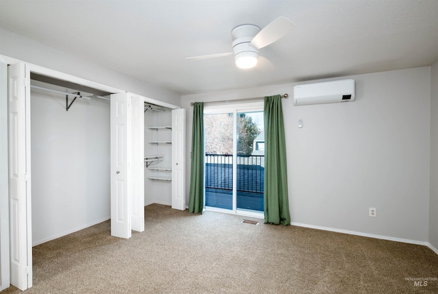 unfurnished bedroom with ceiling fan, carpet, a wall mounted AC, and two closets