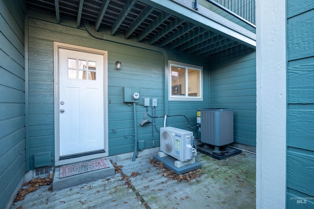 property entrance featuring ac unit and cooling unit