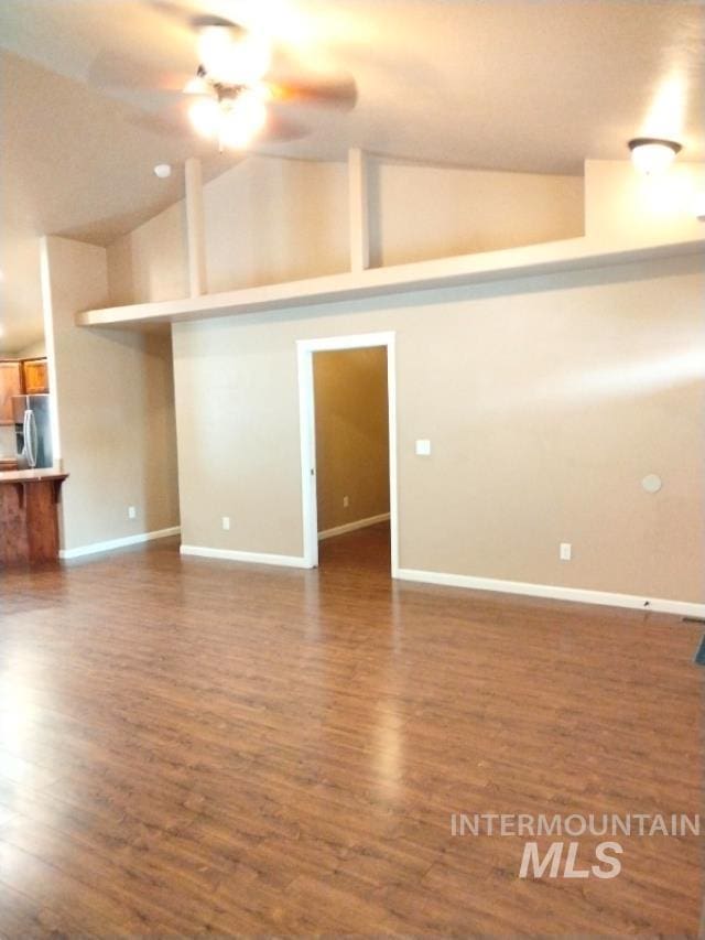 841 Gregory Way, Twin Falls, ID 83301 - unfurnished living room with dark wood-type flooring, baseboards, a ceiling fan, and high vaulted ceiling