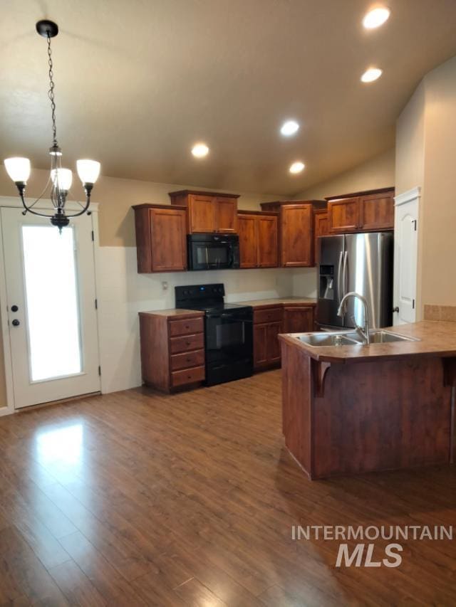 841 Gregory Way, Twin Falls, ID 83301 - kitchen with black appliances, a peninsula, a chandelier, brown cabinets, and recessed lighting