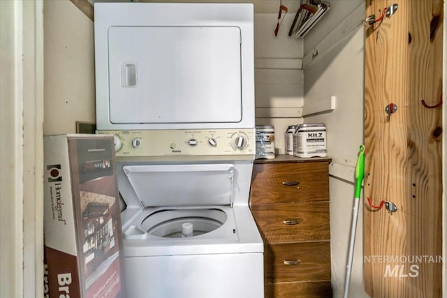 laundry area featuring stacked washer / dryer