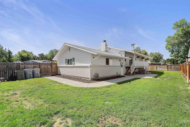 1934 N Cribbens St, Boise, ID 83713 - back of property featuring a chimney, a fenced backyard, stairway, and brick siding