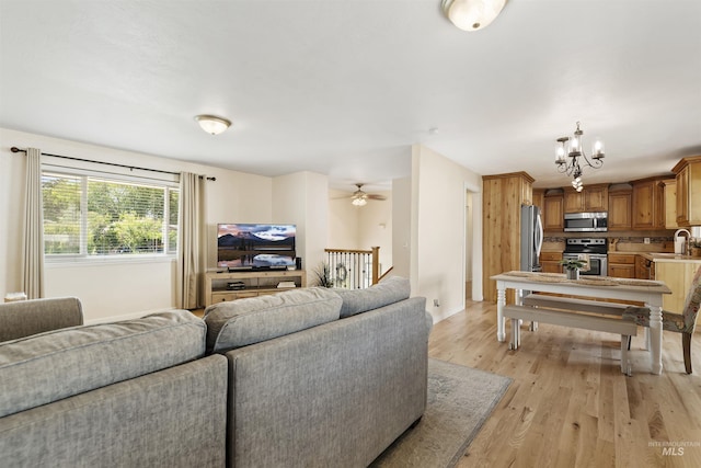 1934 N Cribbens St, Boise, ID 83713 - living area with light wood finished floors, a chandelier, and a ceiling fan