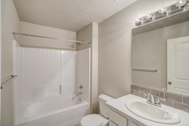 full bathroom featuring vanity, tasteful backsplash, bathing tub / shower combination, toilet, and a textured ceiling