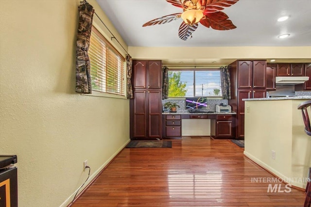 368 W King Rd, Kuna, ID 83634 - kitchen with under cabinet range hood, ceiling fan, dark wood finished floors, baseboards, and a textured wall