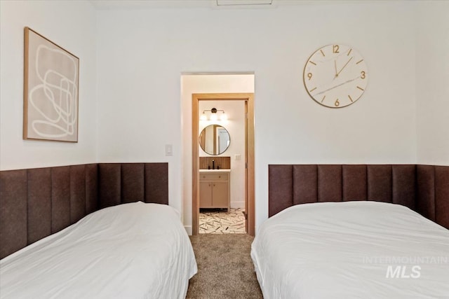 bedroom with carpet flooring and ensuite bath