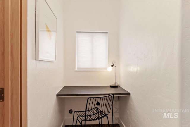 office area with a textured wall