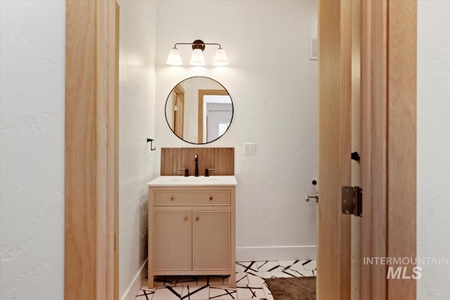 bathroom featuring baseboards and vanity
