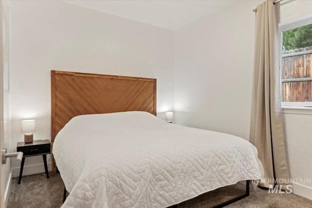 carpeted bedroom featuring baseboards