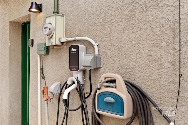 exterior details with stucco siding and electric meter