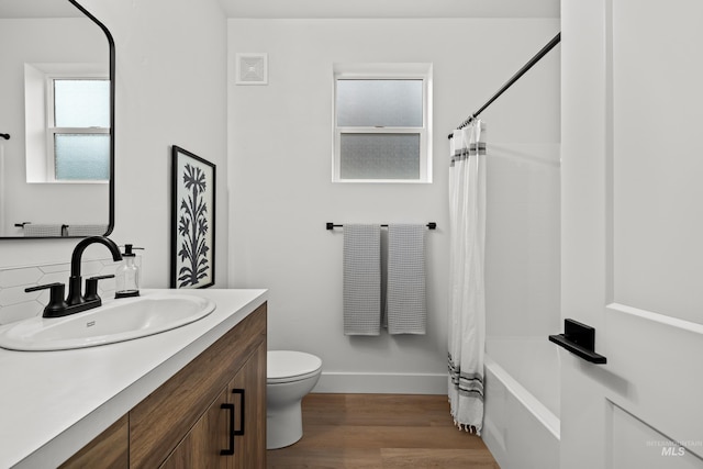 full bathroom with shower / bathtub combination with curtain, toilet, vanity, and wood-type flooring