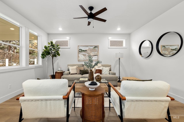 living room featuring ceiling fan and light hardwood / wood-style flooring