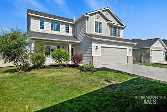 4217 S Leaning Tower Ave, Meridian, ID 83624 - view of front of property with board and batten siding, driveway, a garage, and a front lawn