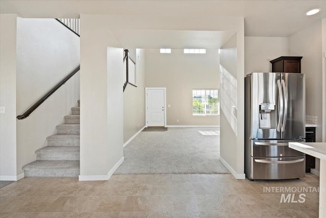 4217 S Leaning Tower Ave, Meridian, ID 83624 - kitchen featuring stainless steel fridge with ice dispenser, dark brown cabinets, light carpet, and light countertops