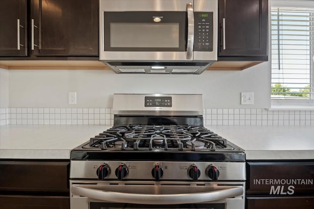 4217 S Leaning Tower Ave, Meridian, ID 83624 - kitchen featuring stainless steel appliances, dark brown cabinetry, light countertops, and tasteful backsplash