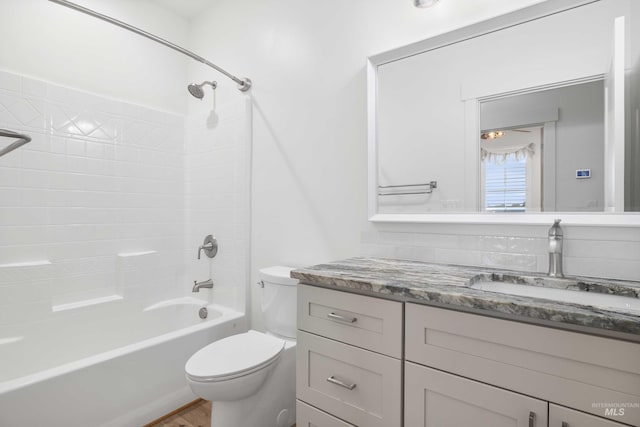 bathroom featuring vanity, toilet, tub / shower combination, and wood finished floors