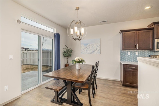 dining area featuring visible vents, baseboards, a chandelier, light wood-type flooring, and recessed lighting